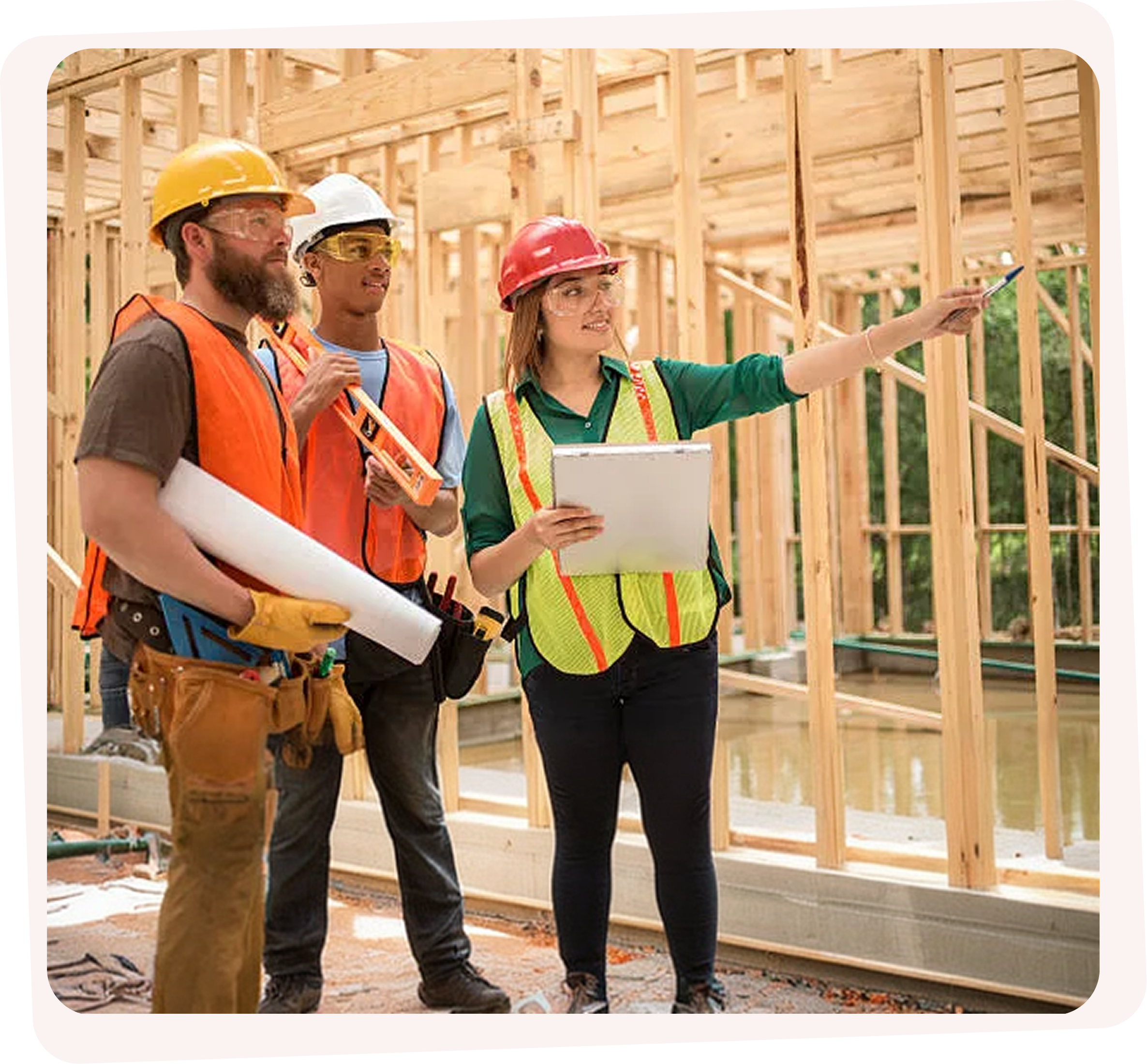 Construction team reviewing blueprints on site